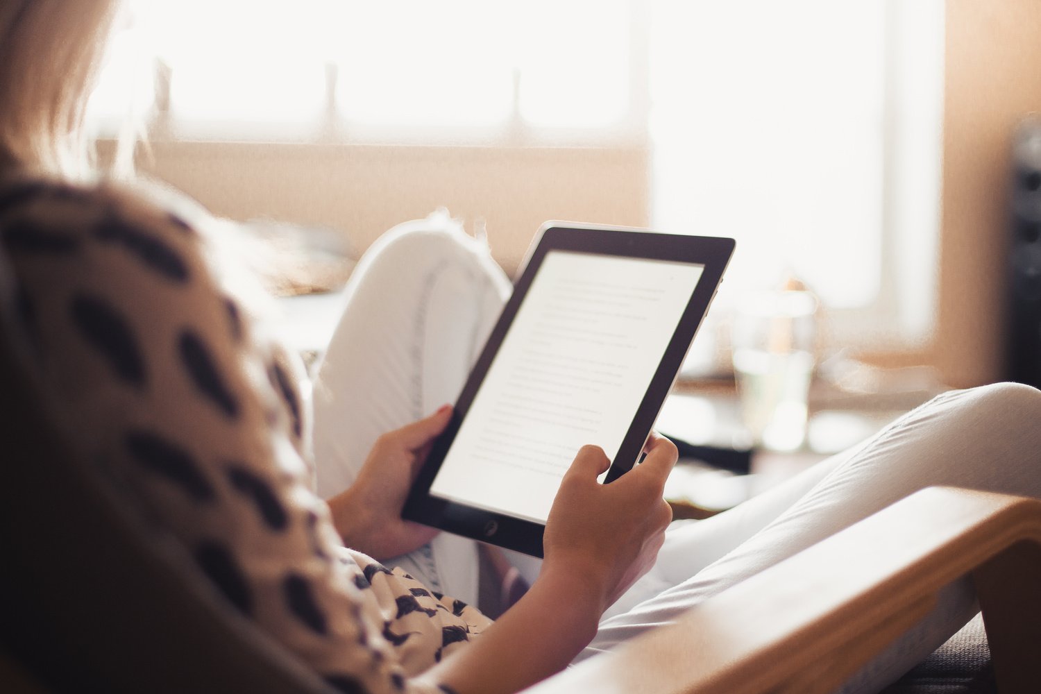 young-woman-reading-a-book-on-her-ipad